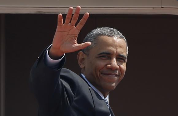 U.S. President Obama waves from Air Force One as he departs Haneda International Airport in Tokyo