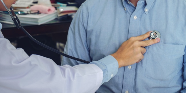 Close up of doctor listening to patient heartbeat with stethoscope on hospital, Physical examination, Medical and health care concept