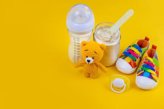 Baby,Milk,And,Accessories,On,A,Yellow,Background.,Selective,Focus.